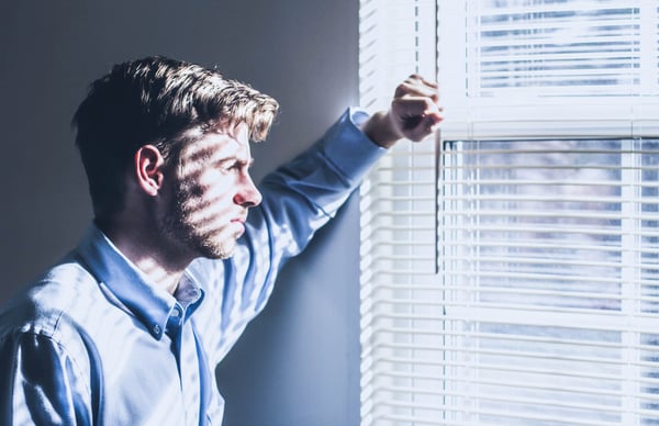 man_looking_out_a_window