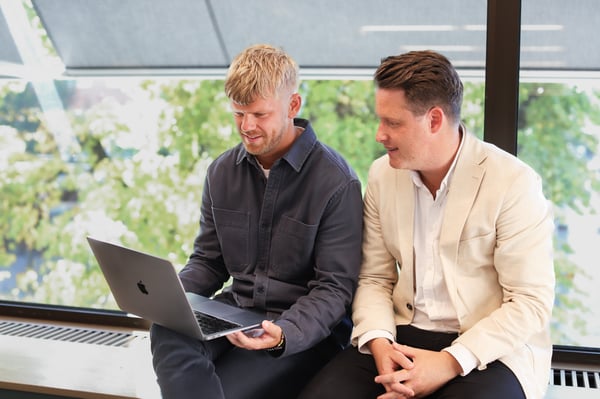 two-guys-looking-at-computer-and-talking