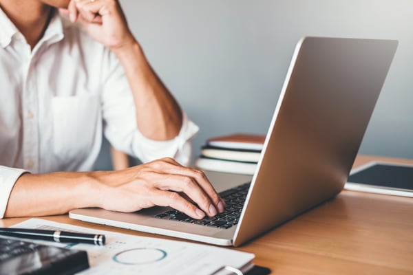 man-sitting-by-his-computer-working