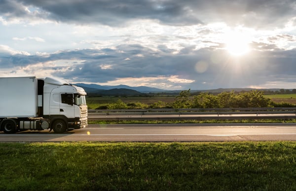 truck-driving-on-road-on-a-sunny-day