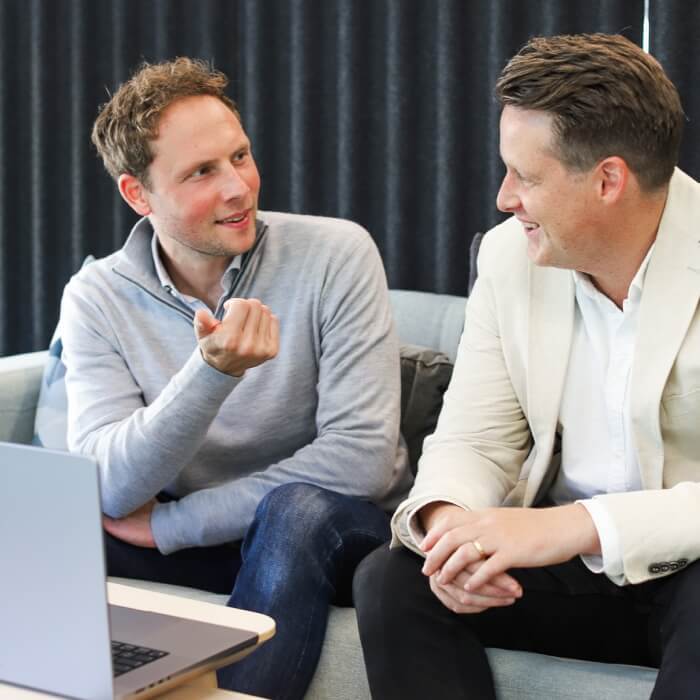 two-men-talking-laptop-1-1