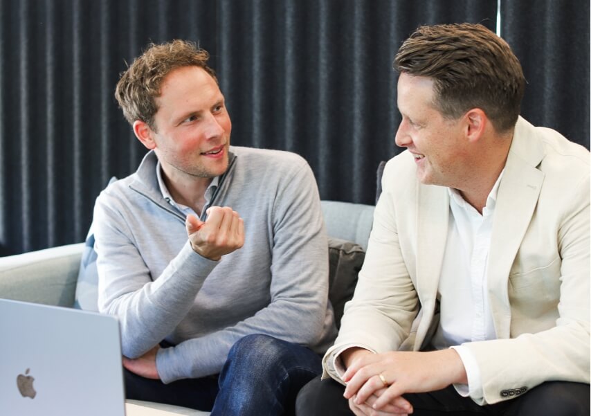 two-men-talking-laptop